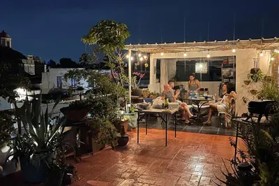 a group of people sitting on a patio at night at Centerpice Colonial Zone in Santo Domingo