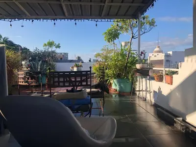 a balcony with chairs and tables on a roof at Centerpice Colonial Zone in Santo Domingo