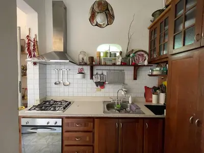 a kitchen with a sink and a stove top oven at Centerpice Colonial Zone in Santo Domingo