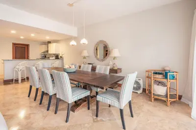 a dining room with a wooden table and chairs at Magnificent Villa at Puerto Bahia in Sabana