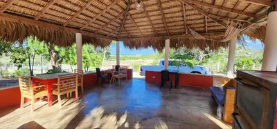a room with a table and chairs in a house at Villa KIKI Ensenada in Punta Rucia