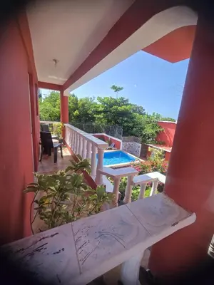 a balcony of a house with a swimming pool at Villa KIKI Ensenada in Punta Rucia