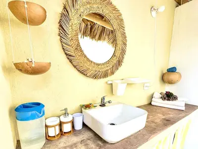a bathroom with a sink and a mirror on the wall at PETRAKl HOMES in Las Galeras