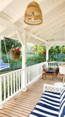 a porch with a white roof and a table and chairs at Casa Alegria Beach Cottage in Las Terrenas