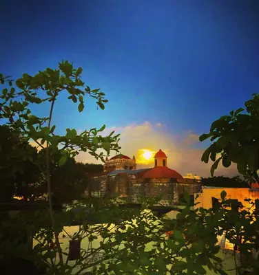 a view of a building with the sunset in the background at Centrico ciudad colonial in Santo Domingo