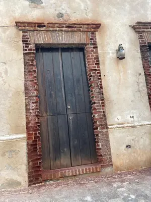 a wooden door on the side of a building at Studio 27 Colonial, Centro Histórico in Santo Domingo