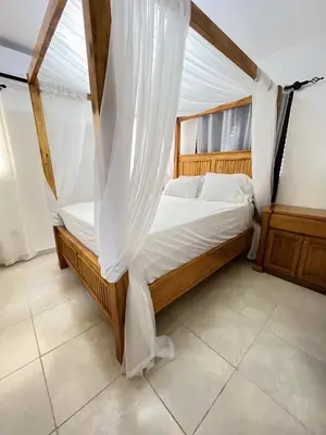 a bedroom with a bed with a mosquito net at Beautiful Condo in La Romana with pool near Caleta Beach in La Romana