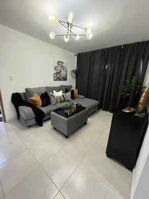 a living room with a couch and a table at Beautiful Condo in La Romana with pool near Caleta Beach in La Romana