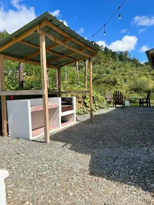 a wooden pavilion with a table and a bench at La Casita de Charo 2, vive y siente el amor, creando recuerdos de vida!! in Constanza