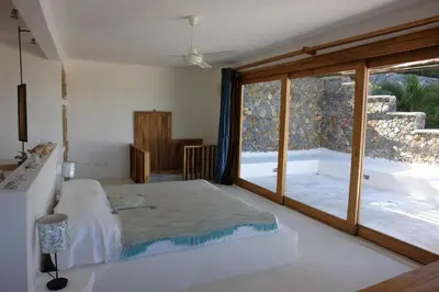 a bedroom with a bed and a large window at Propiedad de alto standing con vista al mar, piscina, tenis, hasta 12 personas in Las Terrenas