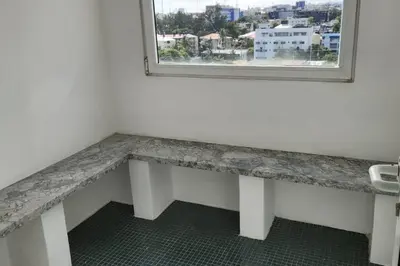 a bathroom with a counter with a sink and a window at Lincoln Suite Pool - Gym - Sauna in Santo Domingo