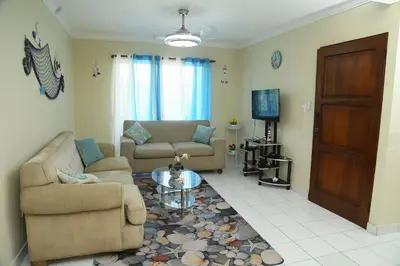 a living room with a couch and a coffee table at Apto CALETA BEACH 3HAB in La Romana