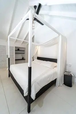 a bedroom with a white bed with a canopy at Casa Panamera- 5br luxury beach Villa Playa Coson in Las Terrenas