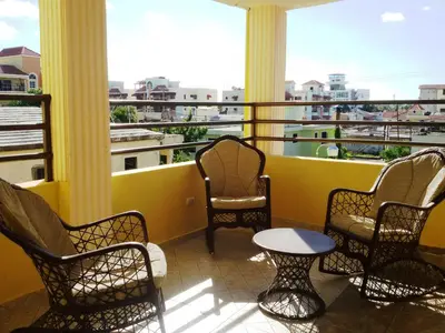 a balcony with chairs and a table on a balcony at Spacious 2Br 2Bath Apartment Terrace & Street View in La Viva