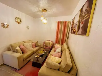 a living room with a couch and a table at Acogedora casa de 2 habitaciones in Villa Isabela