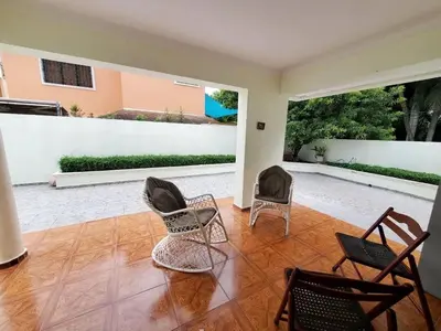 a living room with chairs and a patio at Villa Isabel, NO SMOKING, cerca embajada USA in Santo Domingo