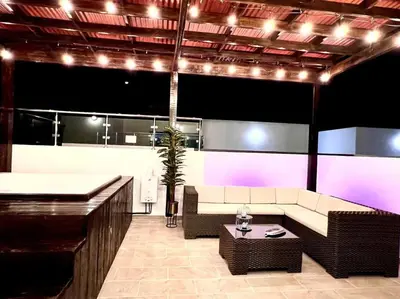 a living room with a couch and a table and lights at Outstanding Pent House w/Jacuzzi in Santiago de los Caballeros