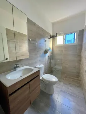 a bathroom with a sink and a toilet and a mirror at Mar Azul in Bayahibe