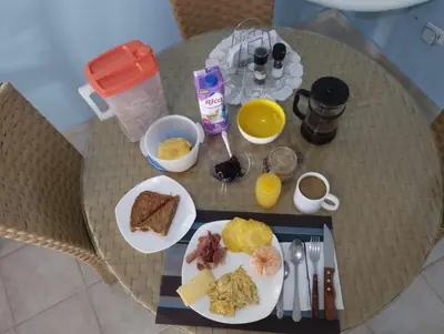a table with plates of breakfast food on it at Best bed and breakfast in Samana Breakfast Included in Santa Bárbara de Samaná