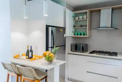 a kitchen with a table with a bowl of fruit on it at Beach Garden I F3 Luxury Condo in Punta Cana