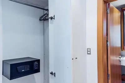 a room with a door with a microwave and a door at Beach Garden I F3 Luxury Condo in Punta Cana