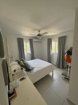 a bedroom with a bed and a ceiling fan at El Conde De Atrini in Santo Domingo