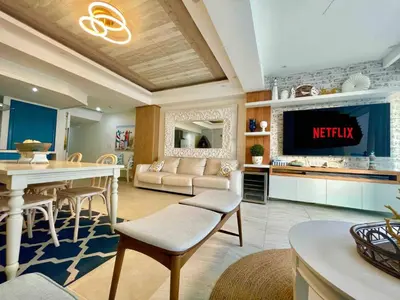 a living room with a tv and a kitchen at 2 Bedroom At The Marbella Towers Beachfront in Juan Pedro