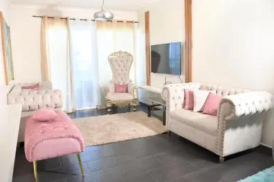 a living room with two chairs and a couch and a tv at Dpto Dream Village Boca Chica frente a la playa in Boca Chica