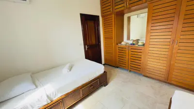 a small bedroom with a bed and a mirror at Don Cesar Beachfront Apartments in Las Terrenas