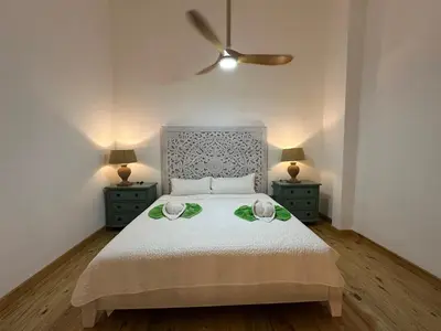 a bedroom with a bed with two night stands and two lamps at Esprit Caribbean Bayahibe in Bayahibe