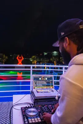 a man working on a laptop computer on a deck at Playa Palmera Beach Resort in Punta Cana
