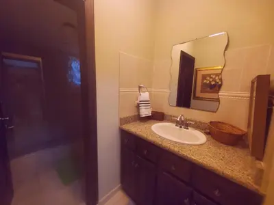 a bathroom with a sink and a mirror at Dominican Art 2 Bedroom condo El Cortecito in Punta Cana