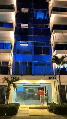 a man standing in front of a building at Torre Real VI in Santiago de los Caballeros