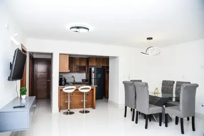 a kitchen and dining room with a table and chairs at Torre Real VI in Santiago de los Caballeros