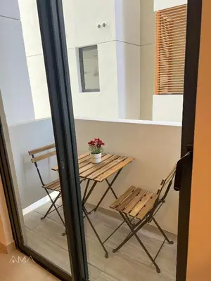 a table and chair in a room with a window at Hermoso refugio céntrico in Santo Domingo