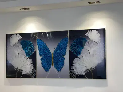 a group of blue and white butterflies hanging on a wall at Mountain View Cibao in Santiago de los Caballeros