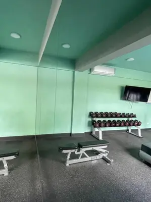 an empty gym with a reflection of a room withairs at Mountain View Cibao in Santiago de los Caballeros