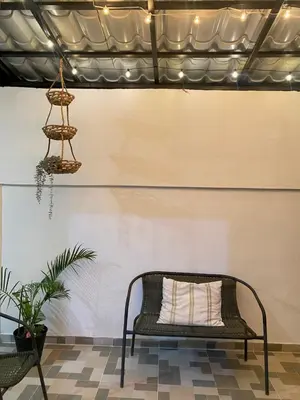a bench in a room with a white wall at Only Room By Merengue House, 8 minutos airport in Monte Adentro