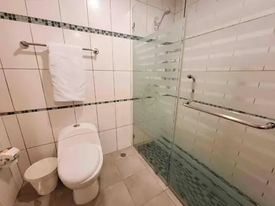 a bathroom with a toilet and a glass shower at 3 Bedrooms At Marbella Beachfront Juan Dolio no820 in Juan Dolio