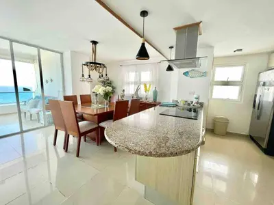 a kitchen and dining room with a table and chairs at 3 Bedrooms At Marbella Beachfront Juan Dolio no820 in Juan Dolio