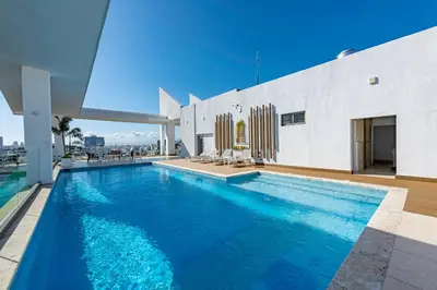 a swimming pool on the roof of a house at Brickell Apart Hotel in Santo Domingo