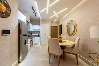 a kitchen and dining room with a table and chairs at Brickell Apart Hotel in Santo Domingo