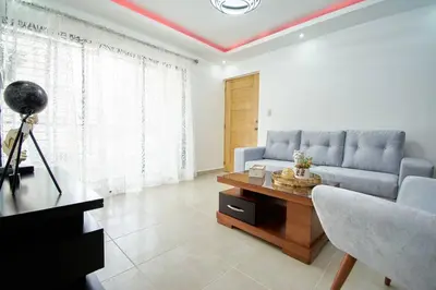 a living room with a blue couch and a table at The apartment you dreamed of 1 in Santiago de los Caballeros