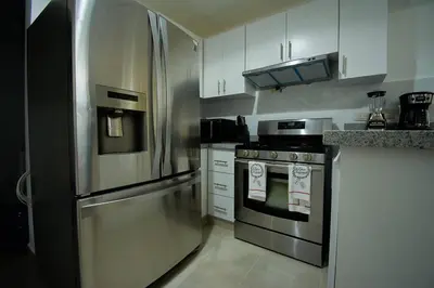 a kitchen with a stainless steel refrigerator and a stove at The apartment you dreamed of 2 ! in Santiago de los Caballeros