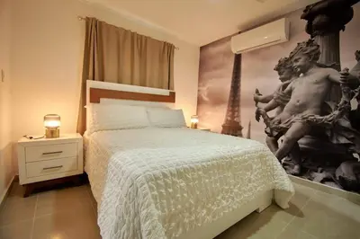 a bedroom with a bed and a painting on the wall at The apartment you dreamed of 2 ! in Santiago de los Caballeros