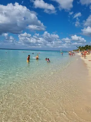 a group of people in the water at a beach at Esmeralda67 Tamarindo in Bayahibe