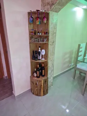 a shelf with wine bottles and glasses on a wall at Villa vacacional Rikheriluz in La Romana