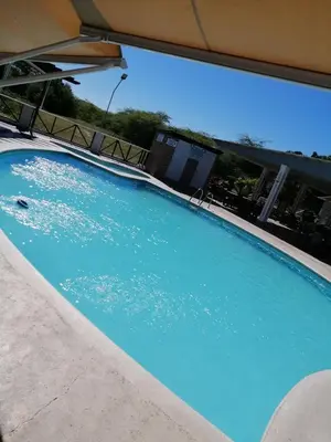 a large swimming pool with a clear blue water at Hotel el barco in Azua de Compostela