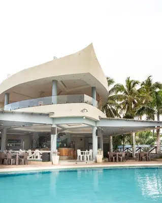 a building with a swimming pool next to a resort at Hotel el barco in Azua de Compostela