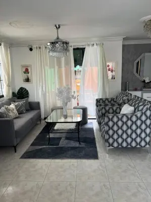 a living room with a couch and a table at Malecon View, Zona Colonial in Santo Domingo